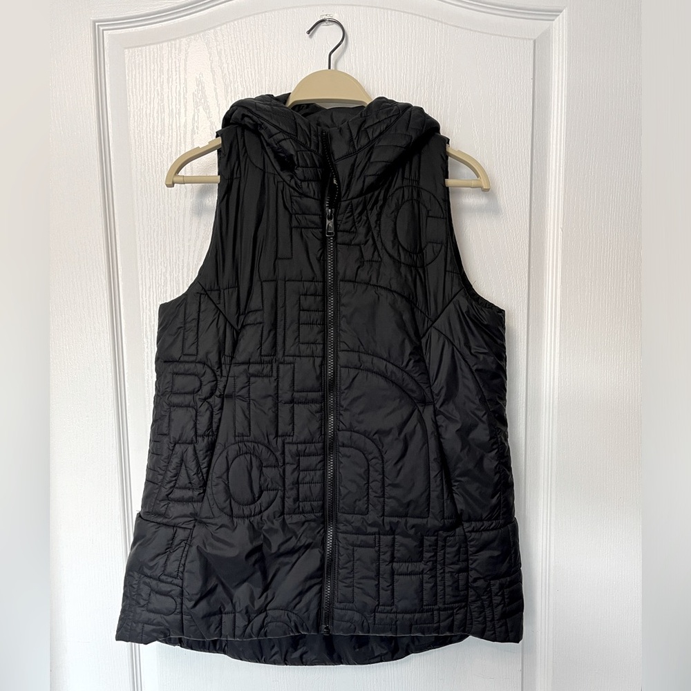 The North Face puffer vest with “THE NORTH FACE” embroidered all over. Size S.